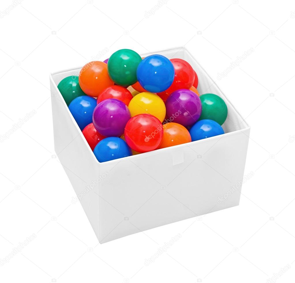 Many colour plastic balls in box on white