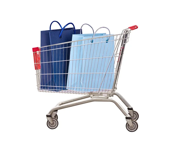 Vozík pro nákupy s taškami na bílé — Stock fotografie