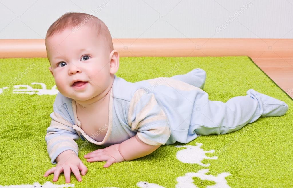 Kid playing on carpet Stock Photo by ©irogova 28010701