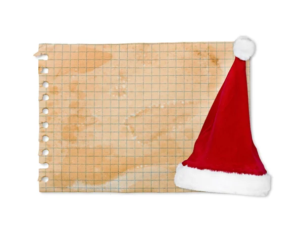 Лист старой бумаги и головной убор Деда Мороза — стоковое фото