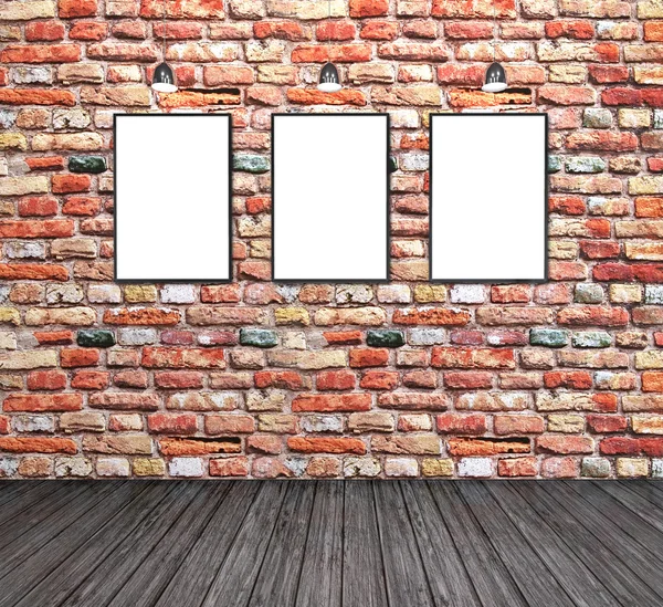 Three empty white frames on a brick wall — Stock Photo, Image