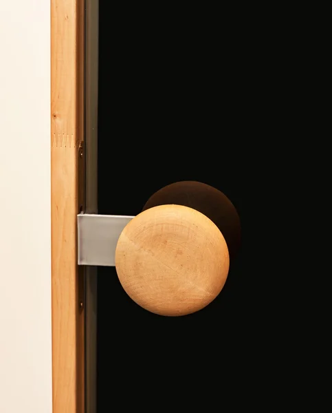 Closed glass black door with the wooden handle — Stock Photo, Image