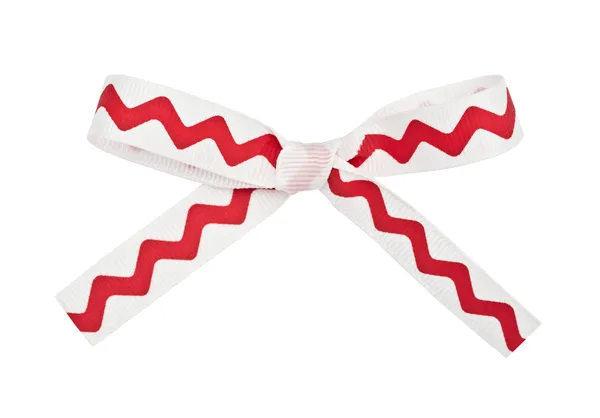 Red ribbon with a white ornament — Stock Photo, Image