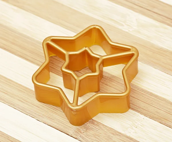 Gold form for cookies a star — Stock Photo, Image