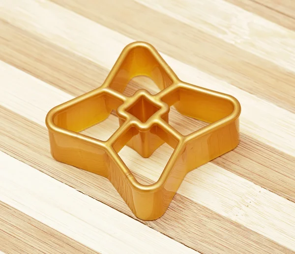 Gold form for cookies a star — Stock Photo, Image