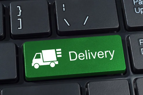 Keyboard button with truck icon and text delivery. — Stock Photo, Image