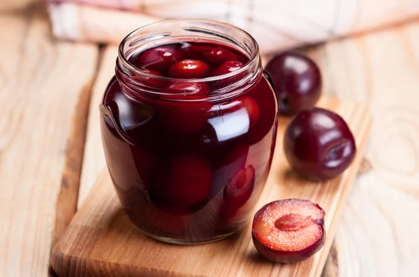 Plum compote in a glass jar. — Stock Photo, Image