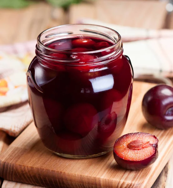 Ripe Plums Wooden Table Glass Jar Closeup — Stock Photo, Image