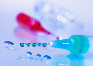 Enjektör iğnesi yeşil sıvı damlacıkları su backgrou düşer