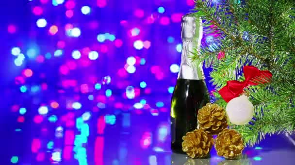Christmas tree decorations with spruce and champagne on bokeh background — Stock Video
