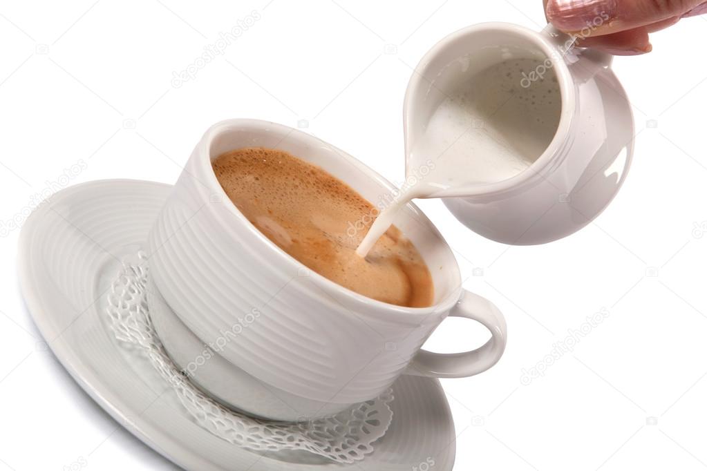 Delicate cream poured into cup of coffee
