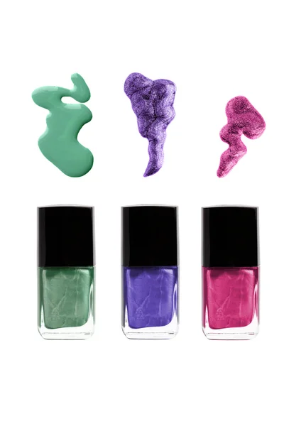 Nagellackflaschen mit Verschütten: grün, violett, lila oder rosa Farben — Stockfoto