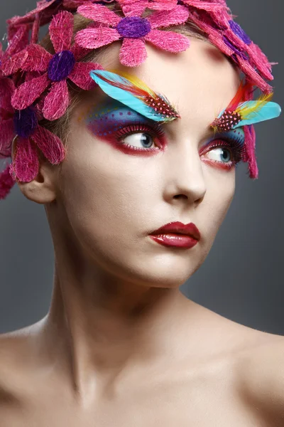 Portrait with flowers and feathers — Stock Photo, Image