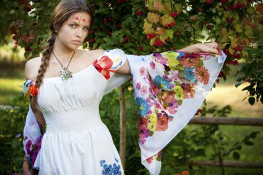 Beautifu ukrainian girl in traditional dress outdoors clipart