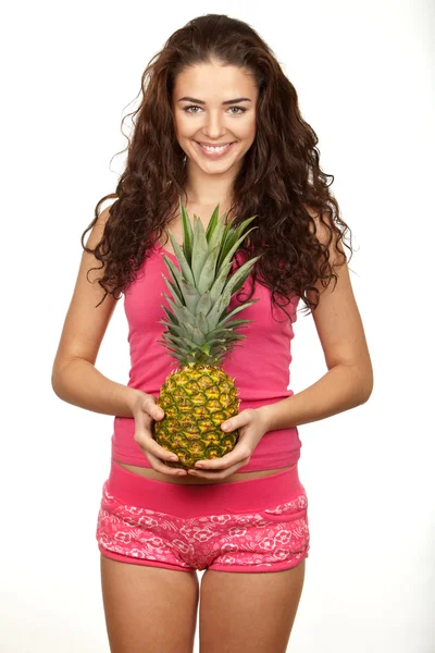 Beautiful brunette holding pineapple — Stock Photo, Image