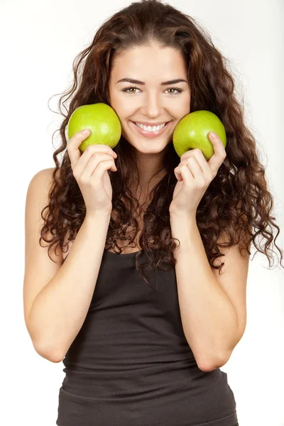Beautiful brunette holding apples — Stock Photo, Image