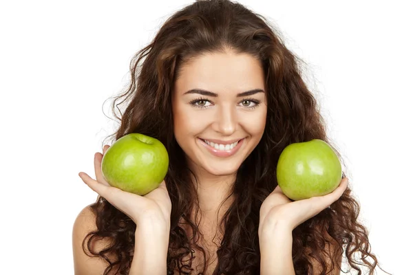 Beautiful brunette holding apples — Stock Photo, Image