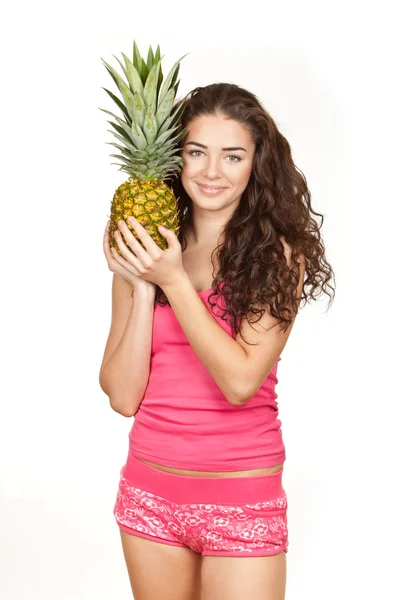 Beautiful brunette holding pineapple — Stock Photo, Image