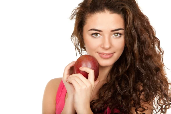 Beautiful brunette holding mango — Stock Photo, Image