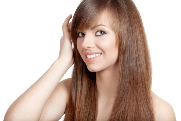 Young smiling brunette woman touches her hair Stock Picture