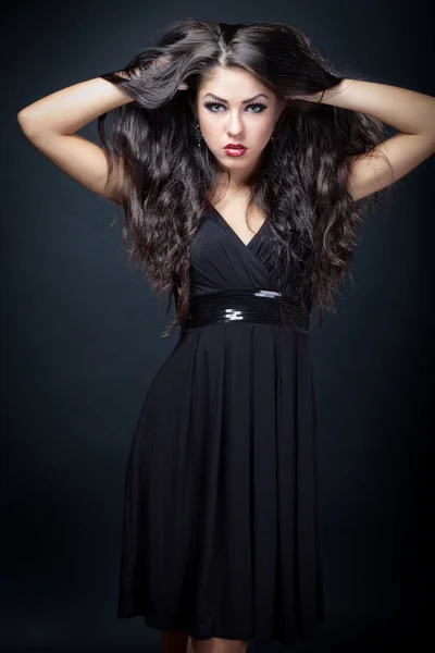 Beautiful young woman in black dress — Stock Photo, Image