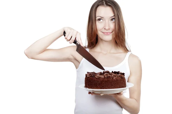 Young woman is going to cut a piece of cake — Stock Photo, Image