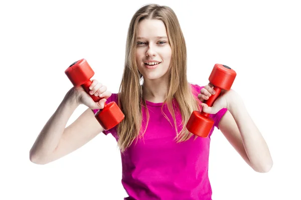 Young beautiful blond girl holding dumbbells — Stock Photo, Image