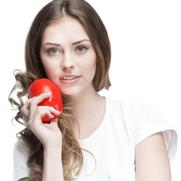 Young beautiful brunette woman holding red pepper — Stock Photo, Image