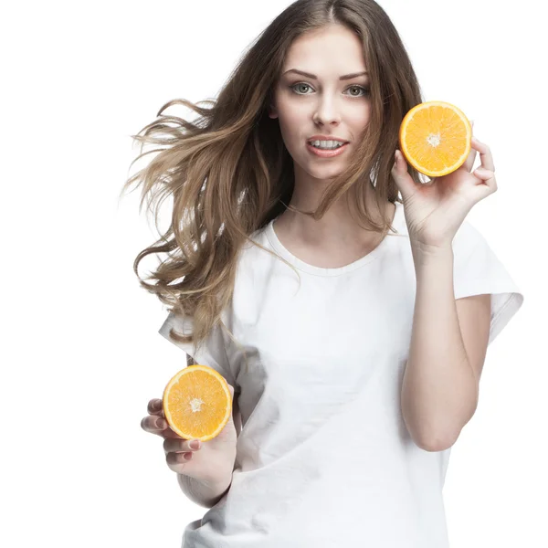 Young beautiful brunette woman holding orange — Stock Photo, Image