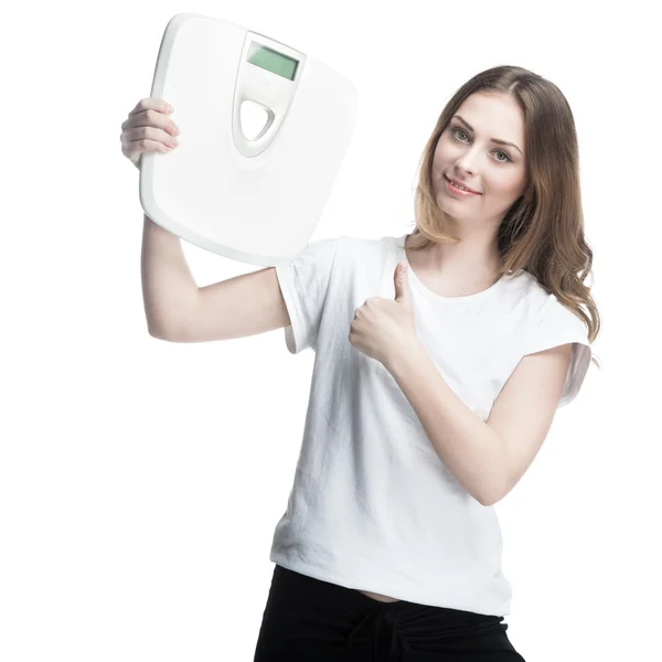 Young girl standing holding scales — Stock Photo, Image