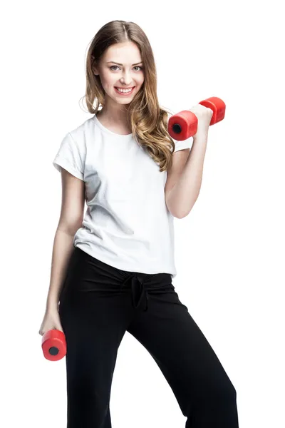 Young beautiful brunette girl holding dumbbells — Stock Photo, Image