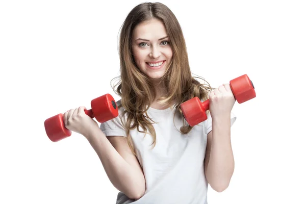 Young beautiful brunette girl holding dumbbells — Stock Photo, Image