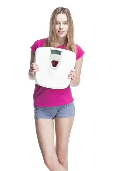 Young beautiful blond girl holding scales — Stock Photo, Image