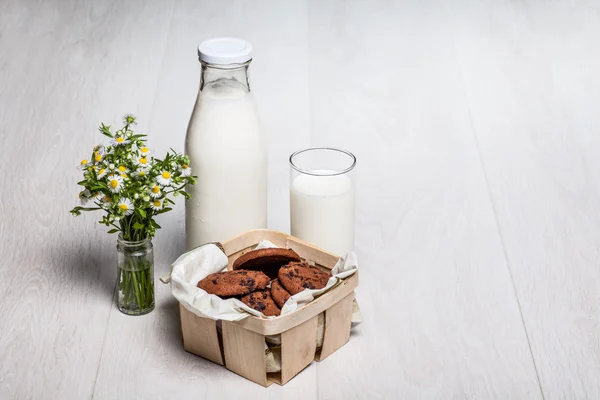 Milk bottle and glass on wooden background — Stock Photo, Image