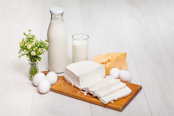 Milk and food on wooden background — Stock Photo, Image
