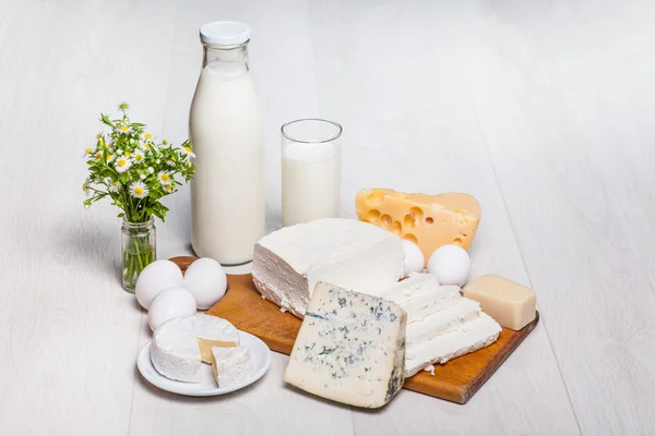 Milk and food on wooden background — Stock Photo, Image