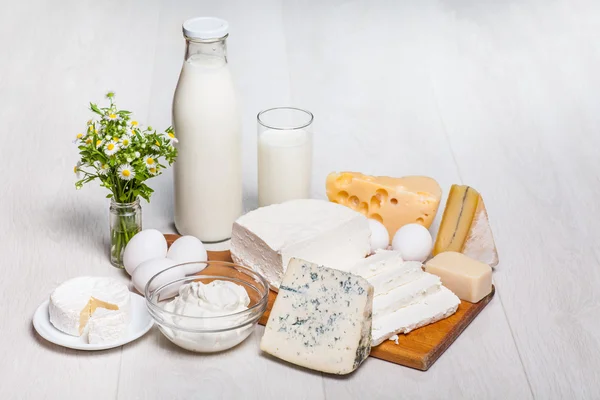 Milk and food on wooden background — Stock Photo, Image
