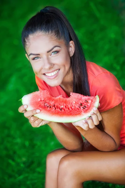 Young beautiful brunette woman holding watermelon — Stock Photo, Image