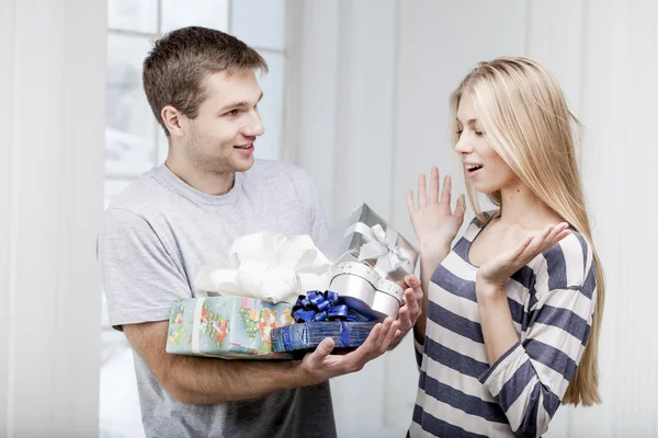 Man giving presents to a young beautiful woman Royalty Free Stock Photos