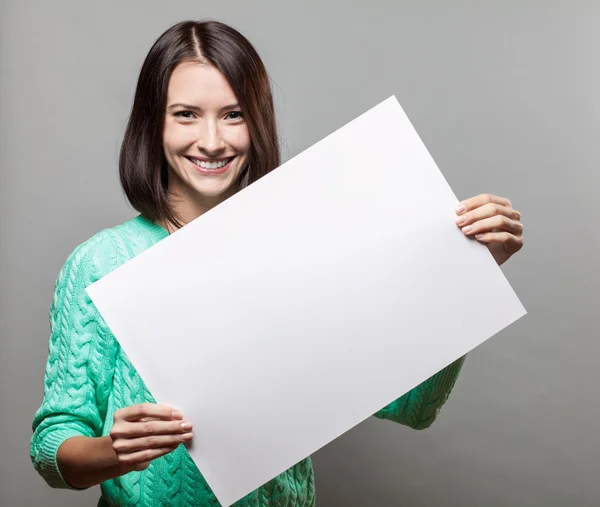 Young brunette woman holding blank sign Stock Picture