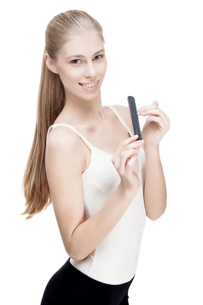 Young blond woman holding nail file — Stock Photo, Image