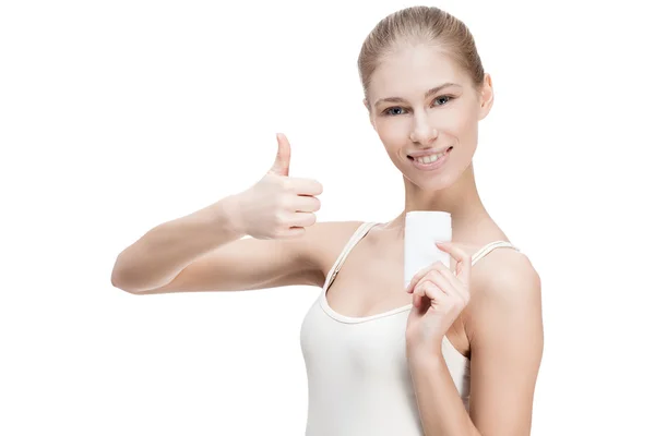 Young blond woman holding antiperspirant — Stock Photo, Image