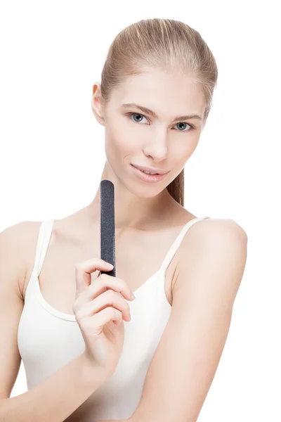 Young blond woman holding nail file — Stock Photo, Image