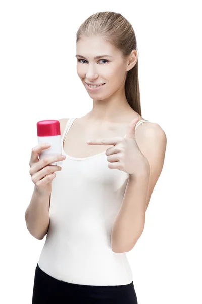 Young blond woman holding antiperspirant — Stock Photo, Image