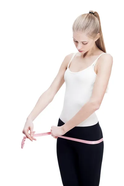 Young blond woman measuring waist — Stock Photo, Image