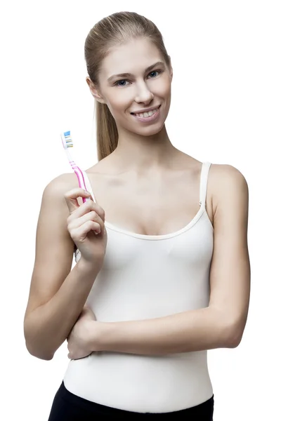 Happy young blond woman with toothbrush — Stock Photo, Image