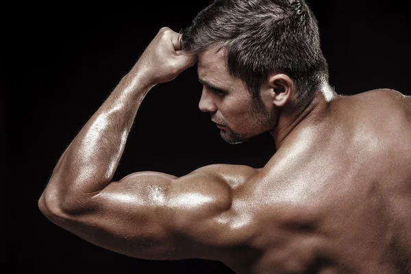 Athletic young man on black background — Stock Photo, Image