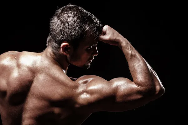 Athletic young man on black background — Stock Photo, Image