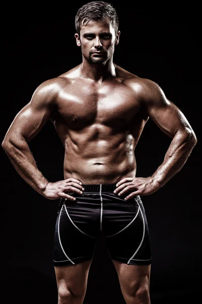 Athletic young man on black background — Stock Photo, Image