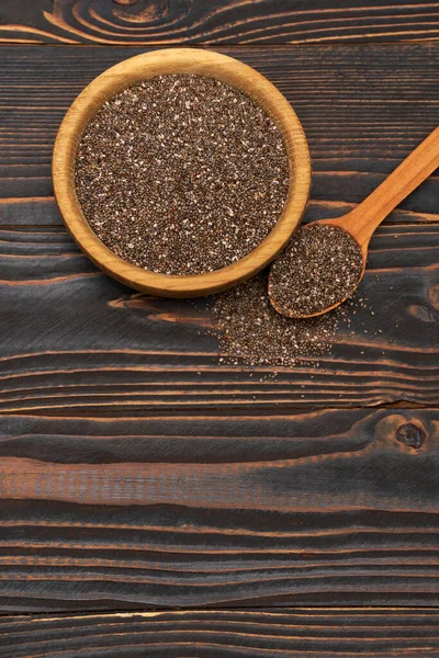 Bowl of organic natural chia seeds close-up on wooden background or table — Stock Photo, Image